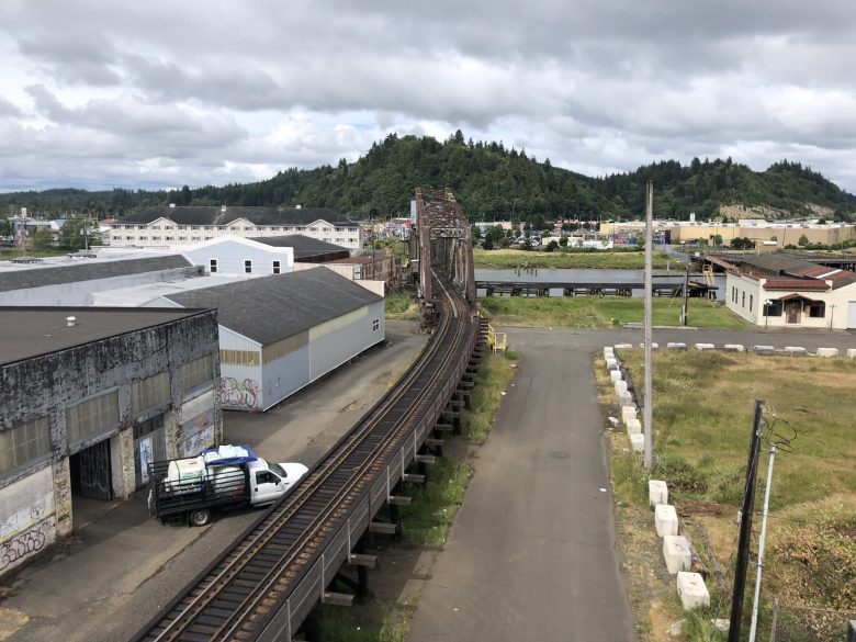 A view from above shows train tracks, the Chehalis River, warehouse, mountains and homes in Aberdeen, Washington.