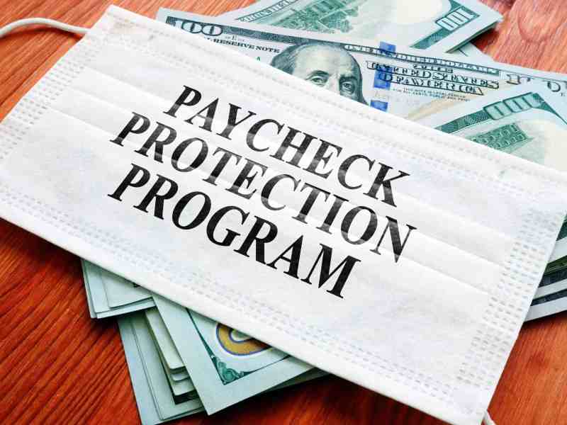 Paycheck Protection Program (PPP) written on the mask and money.