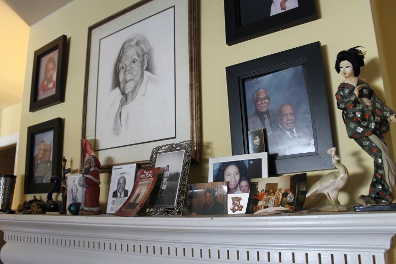 Family portraits are arranged over the mantelpiece in Patricia Robinson's living room in Washington, D.C.