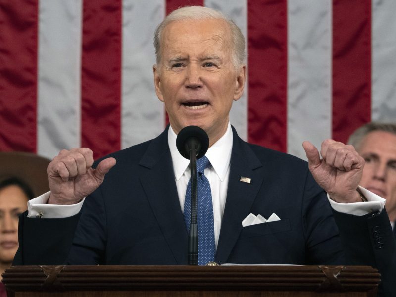 President Joe Biden raises his hands emphatically as he delivers the State of the Union address as Vice President Kamala Harris, behind him on the left, and House Speaker Kevin McCarthy, behind him on the right, listen.