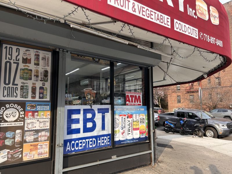A bodega displays a sign that says "EBT accepted here."