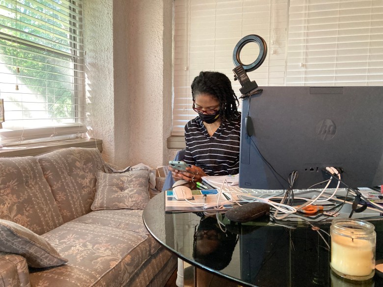 ReShonda Young checks her cell phone in her home office.