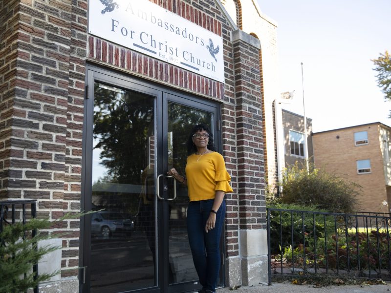 ReShonda Young stands at the double doors outside a church property in Waterloo, Iowa, that she's hoping to purchase.