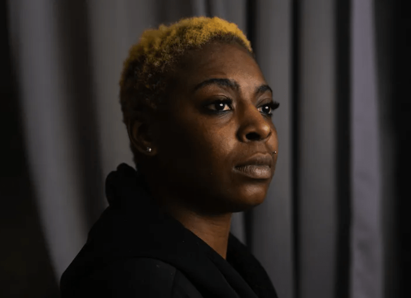 Shambrika Crawford looks off-camera with a serious expression